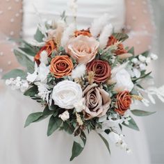 a bride holding a bouquet of flowers in her hands