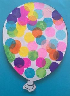 a paper plate with colorful polka dots on it and a white base that has the shape of a hot air balloon