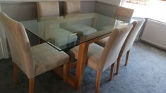 a glass table with four chairs around it