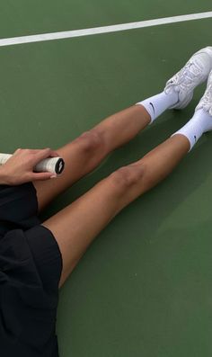 a tennis player is laying on the court with her racquet in his hand