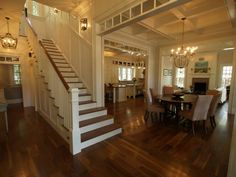 an open floor plan with stairs leading up to the dining room