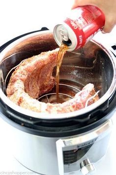 someone is pouring sauce into an electric slow cooker with meat in the bottom and inside