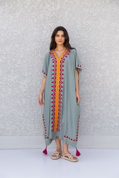 "This beautiful Moroccan butterfly Kaftan has a unique presence to it. It's colorful and most importantly comfortable wear, light and soft and can be used on many occasions - home gatherings, dinners, or just in your home to feel comfortable. Fabric : 80% Egyptian Cotton and 20% Polyester Measurements : Free size. Fits up to 4XL. Also there is a belt that can be used to tighten the dress around the hips. Bust size : 67 inches Length : 57 inches **Note : The kaftan in the video is a different col Bohemian Style Tunic Thobe For Eid, Bohemian Kimono For Beach On Eid, Bohemian Beach Kimono For Eid, Bohemian Kimono For Beach And Eid, Bohemian Eid Beach Kimono, Folk Style V-neck Kaftan For Festival, Bohemian Kimono Tunic For Eid, Bohemian Tunic Kimono For Eid, Bohemian Kaftan With Kimono Sleeves And Floral Embroidery