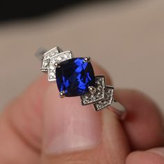 This is a gorgeous handmade creation. Its beauty is its simplicity & Elegance. The 7*7 mm cushion shape faceted lab sapphire is crafted in solid sterling silver and with rhodium plated. All item is sent in a beautiful gift box If you have any idea of design your ring,pls contact me directly. You can realize more lovely stuff clicking the link https://www.etsy.com/shop/knightjewelry?refshopsection_shophome_leftnav Please leave the correct address and you phone number for delivering successful Lab-created Sapphire Rings In Square Cut, Sapphire Cushion Cut Cubic Zirconia Ring, Sapphire Square Cut Ring With Accent Stones, Sapphire Rings With Diamond Cushion Cut, Sapphire Rings With Square Cut And Accent Stones, Silver Sapphire Ring With Cushion Cut, Square Cut Sapphire Ring For Gift, Square Cut Sapphire Ring As Gift, Elegant Adjustable Sapphire Crystal Ring