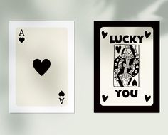 two playing cards with the words lucky and you in black on each card, one has a heart