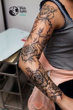 a woman with a flower tattoo on her arm