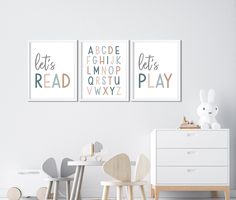 two posters are hanging on the wall in a child's room with white furniture