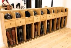 several pairs of boots are lined up on the wall in front of an entry way