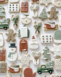 many different decorated cookies on a white surface