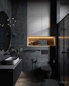 a black and white bathroom with lights on the wall above the toilet, sink and mirror