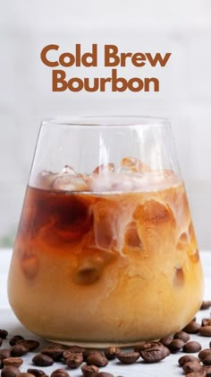 cold beverage in a glass with coffee beans around it