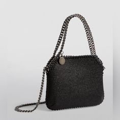 Stella Mccartney Falabella Glitter Mini Crossbody Tote Bag New. Tiny Falabella Tote Features A Shimmering Glitter Finish Elevated With Stella's Iconic Chain Trim. Features: -Chain Crossbody Strap -Dual Chain Handles -Open Top With Magnetic Closure -Interior Slip Pocket -Polyurethane/Nylon -Made In Italy Approximate Size: 7"W X 6"H X 2"D Comes With Dust Bag And Original Shipping Box With Upc Barcode On It. Note: On The Back Side On Top There Is Slightly Visible Line Across The Bag, No Damage What Metallic Evening Bag With Chain Strap, Elegant Metallic Bags For Night Out, Evening Glitter Shoulder Bag, Glamorous Metallic Bag For Night Out, Chic Metallic Bag For Night Out, Elegant Glitter Shoulder Bag, Silver Glitter Bag For Night Out, Chic Glitter Shoulder Bag For Evening, Luxury Glitter Bags For Everyday Use