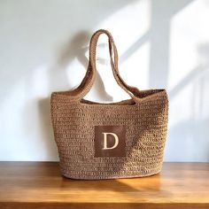 ✔️I made this beautiful bag from camel natural paper rope which is organic cotton. ✔️The interior of the straw summer bag has a magnetic button. Suitable for use as shoulder bag, beach bag or party bag ✔️There is a small vegan leather pocket on the front of the bag. ✔️I can add your initials on the leather pocket. You can personalize the letter. ✔️You can combine your clothes with a straw summer bag on summer days ✔️Handcrrafted in Turkey ✔️Hand-crocheted with care ✔️This bag is light weight yet durable, breathable and environmental at the same time. ✔️The bag hasn't  lining. But the bag has cotton lining option. ✔️This bag has a packable form and does not take up space in the suitcase. Unique for holidays ! ✔️Due to differences in shooting light and monitors, there may be color difference Everyday Light Brown Straw Tote Bag, Everyday Light Brown Tote Straw Bag, Light Brown Crochet Bag For Vacation, Large Capacity Beige Crochet Bag In Natural Fiber, Light Brown Crochet Bag For Summer Beach, Light Brown Crochet Bag For Beach In Summer, Light Brown Crochet Beach Bag For Summer, Light Brown Crochet Shoulder Bag For Beach, Everyday Light Brown Straw Bag For Summer