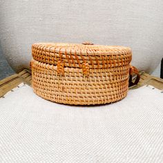 a wicker basket sitting on top of a white cushion next to a toilet seat