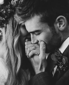 a man and woman are holding their hands to their face as they look at each other