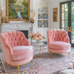 a living room with two pink chairs and a fireplace