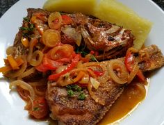 some meat and vegetables on a white plate