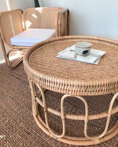 two wicker chairs and a coffee table in a room