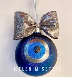 a blue ornament with a silver bow on it