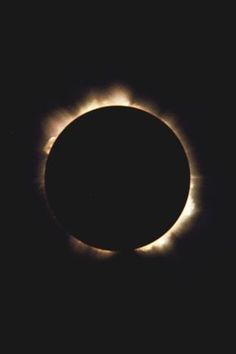 the sun is seen in front of an object that appears to be partially eclipsed