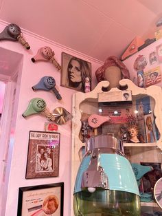 a pink room with various items on the wall