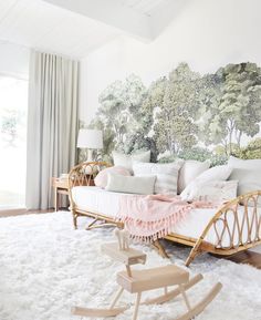 a living room filled with furniture and pillows on top of a white carpeted floor