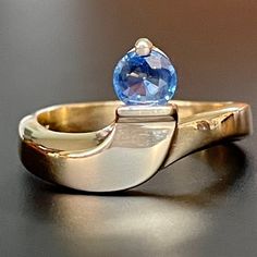 This intriguing 14K gold and natural sapphire ring features elegant lines and a stunning high quality round bright blue sapphire! The stone is very clear and free of eye visible inclusions, and is a most desirable cornflower blue! As measured in setting, the sapphire is approximately.40Ct, measuring 4.9mm in diameter and 2.15mm in depth. The ring is stamped with the 14K gold purity mark, and is a size 6.5US.* The band 3mm wide at the bottom an 4.45mm at it's widest point at the top. The ring wei Ruby Necklace Pendant, Round Sapphire, Blue Sapphire Ring, Ruby Pendant, 18k Gold Jewelry, Solid Gold Jewelry, Blue Sapphire Rings, Natural Blue Sapphire, Cornflower Blue