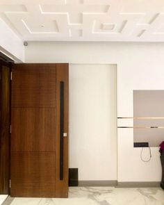 an empty room with wooden doors and white walls