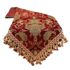 a red and gold table cloth with tassels on it's edges,