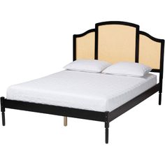 a bed with white sheets and black headboard