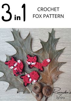 three crochet fox appliques sitting on top of a leaf with acorns