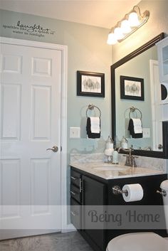 a white toilet sitting next to a bathroom sink