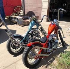 two motorcycles parked next to each other in front of a garage