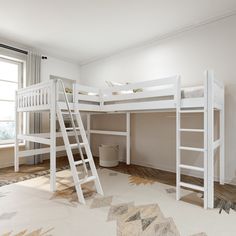 there is a bunk bed with a ladder on the bottom and a rug underneath it