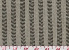 a ruler is next to a fabric with herringbones in grey and brown colors