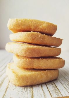 a stack of doughnuts sitting on top of a wooden table next to each other