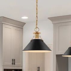 two lights hanging from the ceiling in a kitchen