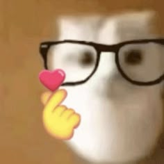 an animated image of a person wearing glasses and holding a heart shaped object in front of their face