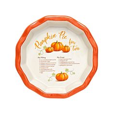 an orange and white plate with pumpkins for two on the side, in front of a white background