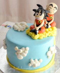 a cake decorated with cartoon characters sitting on top of it