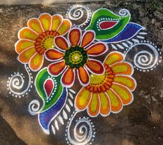 a colorful flower design painted on the ground