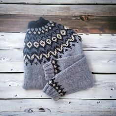 a knitted hat and mittens sitting on top of a wooden floor