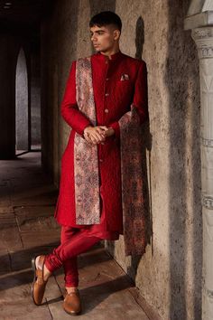 Red full sleeve sherwani with floral quilted pattern and mandarin collared neckline. Paired with kurta, churidar and black paisley print shawl.
Components: 4
Type Of Work: Floral
Neckline: Mandarin collar
Sleeve Type: Full sleeves
Fabric: Silk, Chanderi, Lining: Shantoon
Color: Red
Other Details: 
Front button detailing
Note: Pocket square worn by the model is not for sale
Occasion: Destination Wedding - Aza Fashions Red Kurta, Mens Sherwani, Groom Looks, Indian Wedding Wear, Luxury Wear, Quilted Pattern, Pernia Pop Up Shop, Fabric Silk, Red Silk