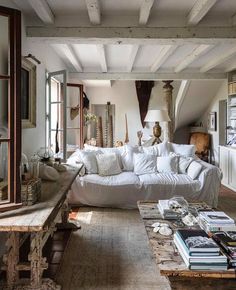 a living room filled with lots of white furniture