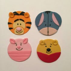 four different shaped magnets with winnie the pooh and tigger faces