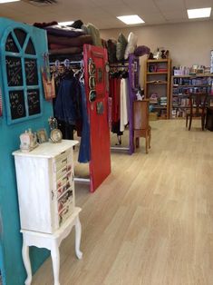 the inside of a clothing store with wooden floors