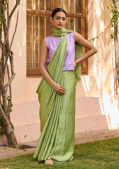 Moss green saree featuring handwoven zari stripes with gold threads with tassel detailing on the pallu. - Aza Fashions Green Slub Silk Pre-draped Saree For Diwali, Green Tussar Silk Pre-draped Saree With Dupatta, Festive Pista Green Handloom Pre-draped Saree, Pista Green Raw Silk Pre-draped Saree For Diwali, Designer Pre-draped Saree With Tassels, Traditional Green Slub Silk Pre-draped Saree, Green Handloom Chanderi Pre-draped Saree, Pista Green Cotton Silk Pre-draped Saree With Cutdana, Elegant Green Handloom Pre-draped Saree