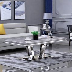 a living room with couches, chairs and a coffee table in silver color scheme