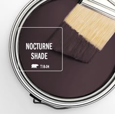 a paint can with the words nocturine shade and a brush on it