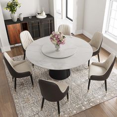 a dining room table with chairs and a rug on the floor in front of it